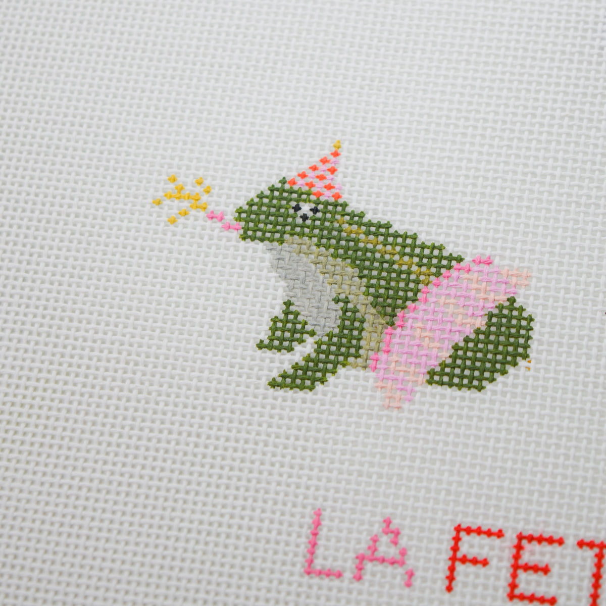Party Frog needlepoint canvas from La Fête Needlepoint’s Party Animals collection